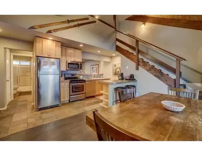 a kitchen with a table and a refrigerator at Tramway near Heavenly/ Dogs OK/ New Heating & Air in Stateline