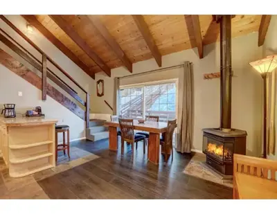 a dining room with a table and a wood stove at Tramway near Heavenly/ Dogs OK/ New Heating & Air in Stateline