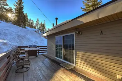 a deck with a table and a grill on a building at Tramway near Heavenly/ Dogs OK/ New Heating & Air in Stateline