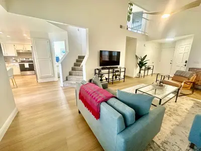 a living room with a couch and a tv at Tranquil Getaway in Fresno