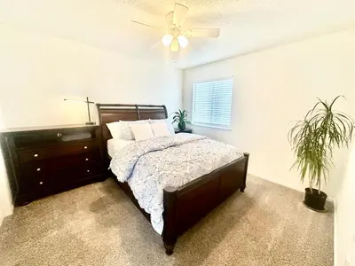 a bedroom with a bed and a ceiling fan at Tranquil Getaway in Fresno