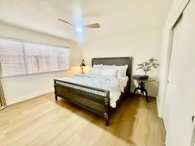 a bedroom with a bed and a table in it at Tranquil Getaway in Fresno