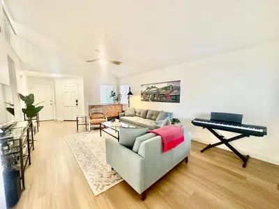 a living room with a couch and a piano at Tranquil Getaway in Fresno