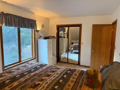 a teddy bear sitting on a bed in a bedroom at Gold Country Serenity! 45 Minutes to Powder! in Grass Valley