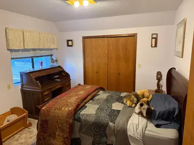 two dogs laying on a bed in a bedroom at Gold Country Serenity! 45 Minutes to Powder! in Grass Valley