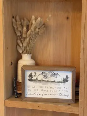 a sign on a shelf with a vase with flowers at Lakeside Condo Close to Slopes Excellent Location in Tahoe Vista