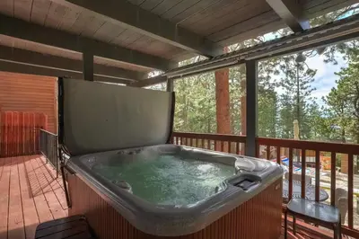 a jacuzzi tub on a screened in deck at Hot TubSaunaPoolPrivate Beach Tahoe Oasis in Zephyr Cove