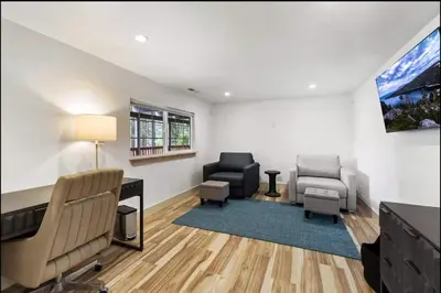 a living room with two chairs and a desk and a tv at Hot TubSaunaPoolPrivate Beach Tahoe Oasis in Zephyr Cove