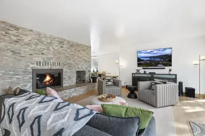 a living room with a couch and a fireplace at Hot TubSaunaPoolPrivate Beach Tahoe Oasis in Zephyr Cove