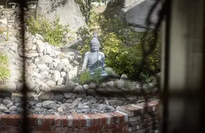 a statue sitting on a pile of rocks at Hot TubSaunaPoolPrivate Beach Tahoe Oasis in Zephyr Cove