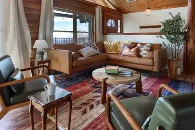 a living room with a couch and a table at Sierra Mountain View Retreat in Coarsegold