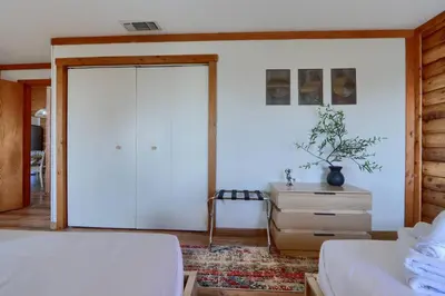 a bedroom with a bed and a closet and a dresser at Sierra Mountain View Retreat in Coarsegold