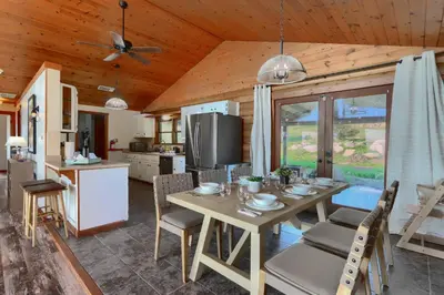 a kitchen and dining room with a table and chairs at Sierra Mountain View Retreat in Coarsegold