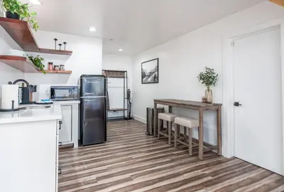 a kitchen with a table and a refrigerator at The Four Daughters Inn in Oakhurst