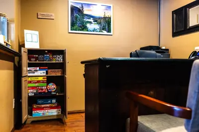 a book shelf next to a desk in a room at The Sierra House in Mammoth Lakes