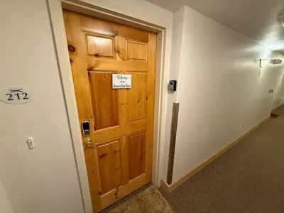 a wooden door in a hallway with a sign on it at Family Ski Getaway in Kirkwood
