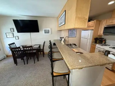 a kitchen with a counter and a kitchen with a table at Family Ski Getaway in Kirkwood