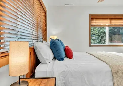 a bedroom with a bed with pillows and a window at Tahoe City Retreat - Creekside Deck & Hot Tub in Tahoe City