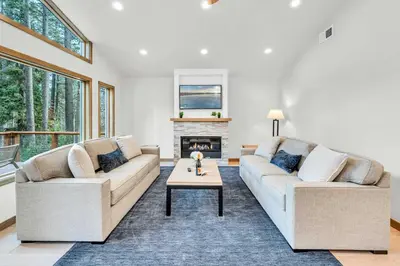 a living room with two couches and a fireplace at Tahoe City Retreat - Creekside Deck & Hot Tub in Tahoe City