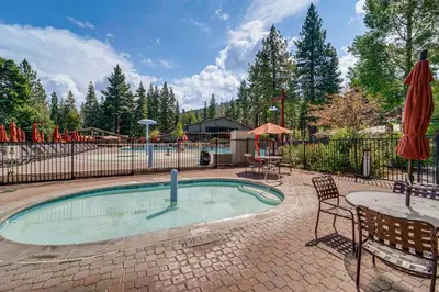 a small swimming pool with a table and a playground at Walk to Gondola Truckee Retreat with Resort Perks! in Truckee