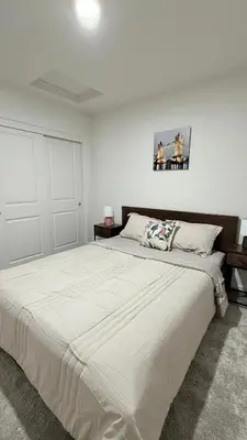 a white bedroom with a large white bed in it at New Holiday Retreat in Merced in Merced