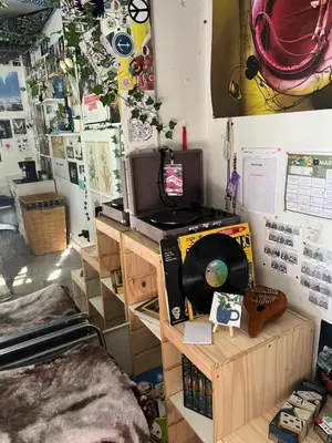 a room with a desk with a cd and a television at Cozy Artistic Teen Room, Fun & Full of Personality in Bodfish