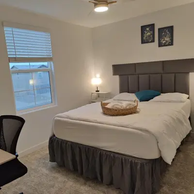 a bedroom with a large bed with a basket on it at The Orchid house !! Your home away from home Gateway to Yosemite & UC Merced this for a Room in Merced