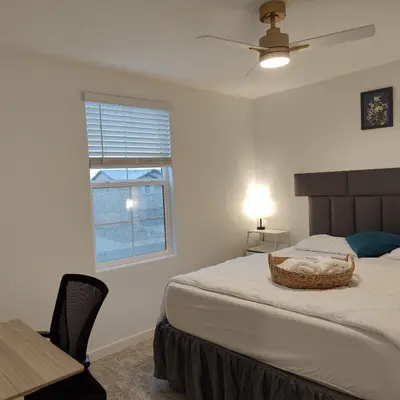 a bedroom with a large bed and a window at The Orchid house !! Your home away from home Gateway to Yosemite & UC Merced this for a Room in Merced