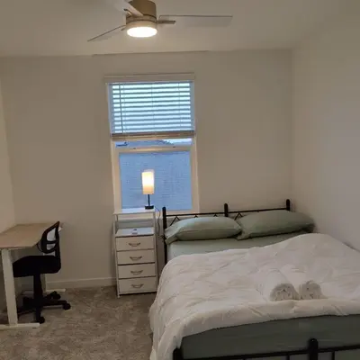 a bedroom with two beds and a desk and a window at The Orchid house !! Your home away from home Gateway to Yosemite & UC Merced this for a Room in Merced