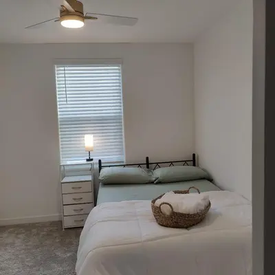 a bedroom with two beds and a ceiling fan at The Orchid house !! Your home away from home Gateway to Yosemite & UC Merced this for a Room in Merced