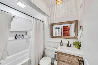 a bathroom with a toilet and a tub and a sink at Cozy Cabin- Large Deck , Near the Slopes in Homewood