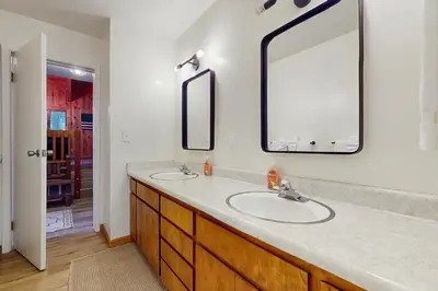 a bathroom with two sinks and a large mirror at Tahoe Alpine and Lake Escape in Carnelian Bay