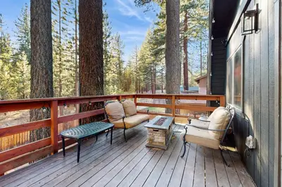 a porch with chairs and a table on a house at Charming Cabin in South Lake Tahoe