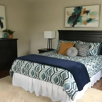 a bedroom with a bed with a blue comforter and pillows at PINECREST MAMMOTH LAKES in Mammoth Lakes