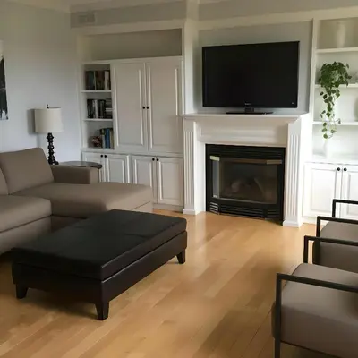 a living room with a couch and a tv on a fireplace at PINECREST MAMMOTH LAKES in Mammoth Lakes