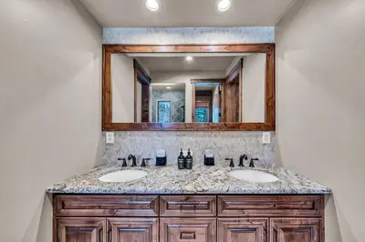 a bathroom with two sinks and a mirror at South Lake Tahoe Escape - Private Hot Tub Pool in South Lake Tahoe