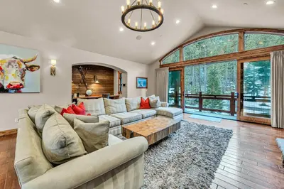 a living room with a couch and a table at South Lake Tahoe Escape - Private Hot Tub Pool in South Lake Tahoe