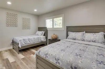 a bedroom with a bed and a window at 2 Mi to UC Merced Modern Home with Private Yard in Merced