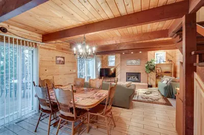 a dining room with a wooden table and chairs at 3 Mi to Calaveras Big Trees Group-Ready Mtn Cabin in Arnold