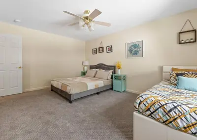 a bedroom with two beds and a ceiling fan at Hot Tub and Game Room 15 mi to Yosemite South Gate in Oakhurst