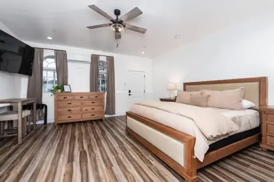 a bedroom with a bed and a ceiling fan at Kinslee Suite at The Four Daughters Inn in Oakhurst