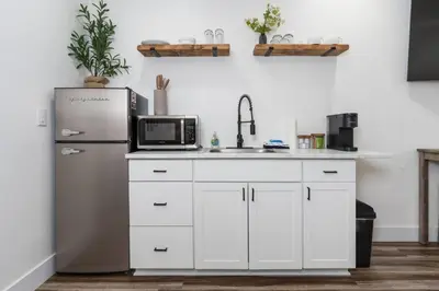 a kitchen with a refrigerator and a microwave at Kinslee Suite at The Four Daughters Inn in Oakhurst