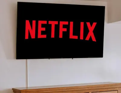 a screen with a netflix sign on a wall at Peytons Luxury Suite at The Four Daughters Inn in Oakhurst