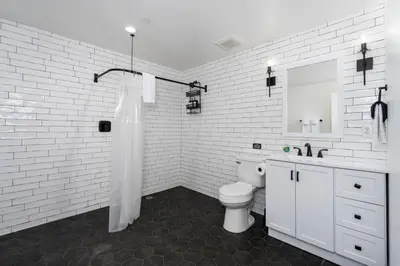a white bathroom with a toilet and a sink at Ryann Suite at The Four Daughters Inn in Oakhurst