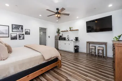 a bedroom with a bed and a ceiling fan at Ryann Suite at The Four Daughters Inn in Oakhurst