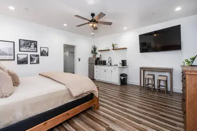 a bedroom with a bed and a ceiling fan at Ryann Suite at The Four Daughters Inn in Oakhurst