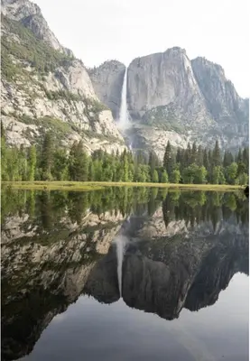 a reflection of a waterfall in a mountain lake at Ryann Suite at The Four Daughters Inn in Oakhurst