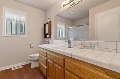 a bathroom with two sinks and a toilet at Harmony Home- EV Charger in Oakhurst
