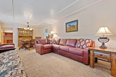 a living room with a couch and a table at Harmony Home- EV Charger in Oakhurst