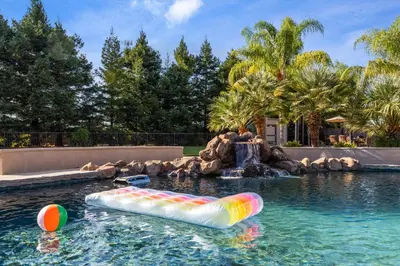 an inflatable pool in a backyard with a water park at Oasis on the vine - Custom Luxury Resort Amenities in Lodi